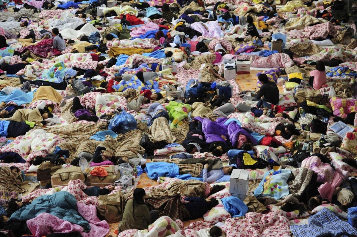 South Koreans sleep at a Jindo gymnasium used as a gathering point for relatives of the missing passengers aboard a capsized ferry.
