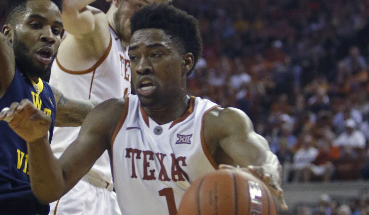 Texas' Isaiah Taylor drives the ball against West Virginia's Tarik Phillip on Feb. 16.