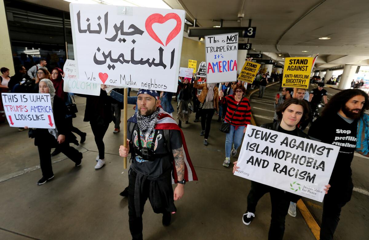Protesters rallying against the first travel ban signed by President Trump march around Los Angeles International Airport in February.