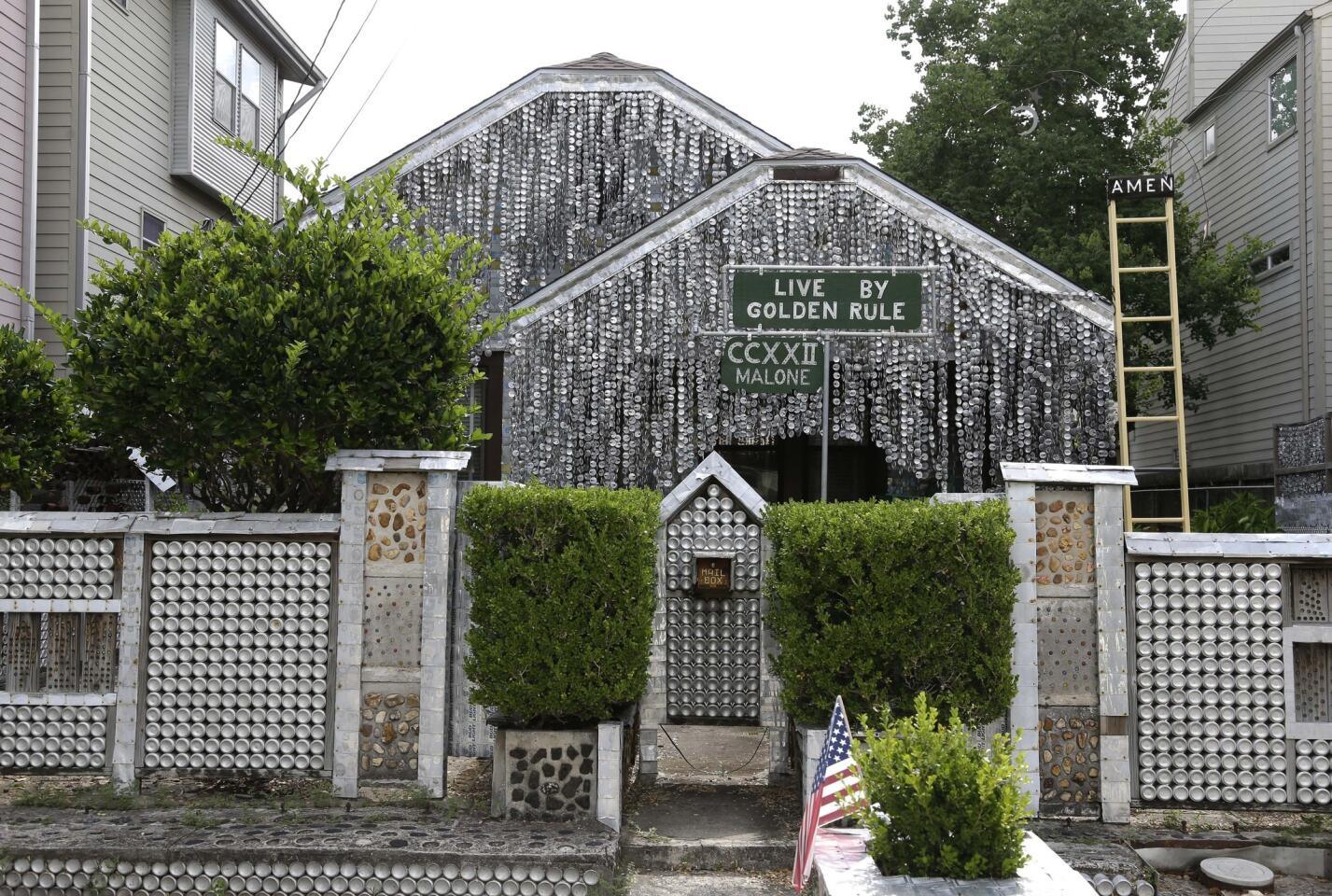 The Beer Can House, a Houston landmark, sits between newer homes.