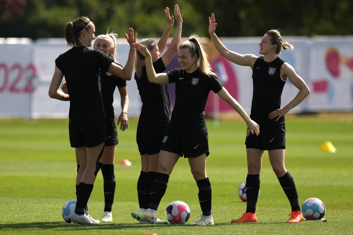 From left, England's players Jill Scott, Chloe Kelly, Lauren Hemp, and and Ellen White cheer during a training session ahead of the Women Euro 2022 quarter final soccer match between England and Spain, at the Lensbury training center in Teddington, London, Tuesday, July 19, 2022. (AP Photo/Alessandra Tarantino)