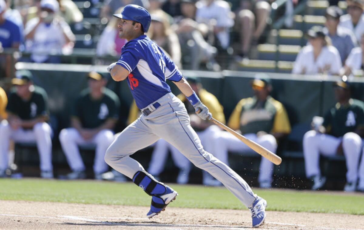 Dodgers outfielder Andre Ethier hits a single during Monday's 7-3 exhibition loss to the Oakland Athletics.