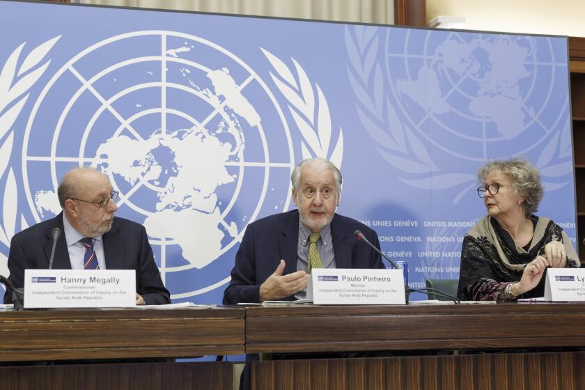Brazilian Paulo Pinheiro, centre, Chairperson of the Commission of Inquiry on Syria, sitting between Egyptian Hanny Megally, left, Member of the Independent Commission of Inquiry on the Syria, and British Lynn Welchman, right, Member of the Independent Commission of Inquiry on the Syrian Arab Republic, talks to the media during a press conference, before presenting the last report by the Commission of Inquiry on the Syrian Arab Republic on the human rights situation in Syria at the 52nd session of the Human Rights Council, at the European headquarters of the United Nations in Geneva, Switzerland, Monday, March 13, 2023. (Salvatore Di Nolfi/Keystone via AP)