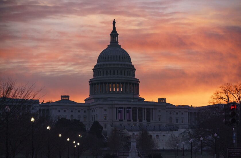 Dawn breaks at the Capitol in Washington, Monday, Jan. 11, 2021. 