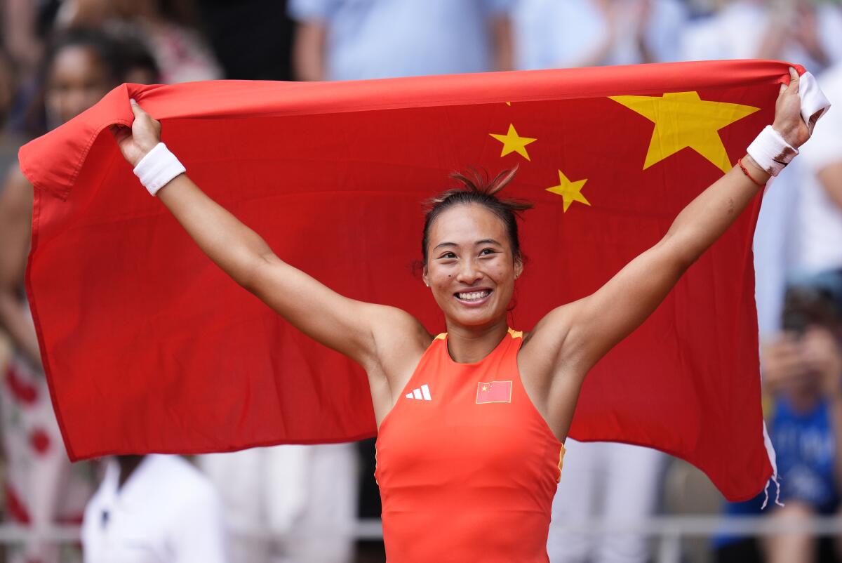 China's Zheng Qinwen celebrates after defeating Croatia's Donna Vekic for gold in the women's singles final.