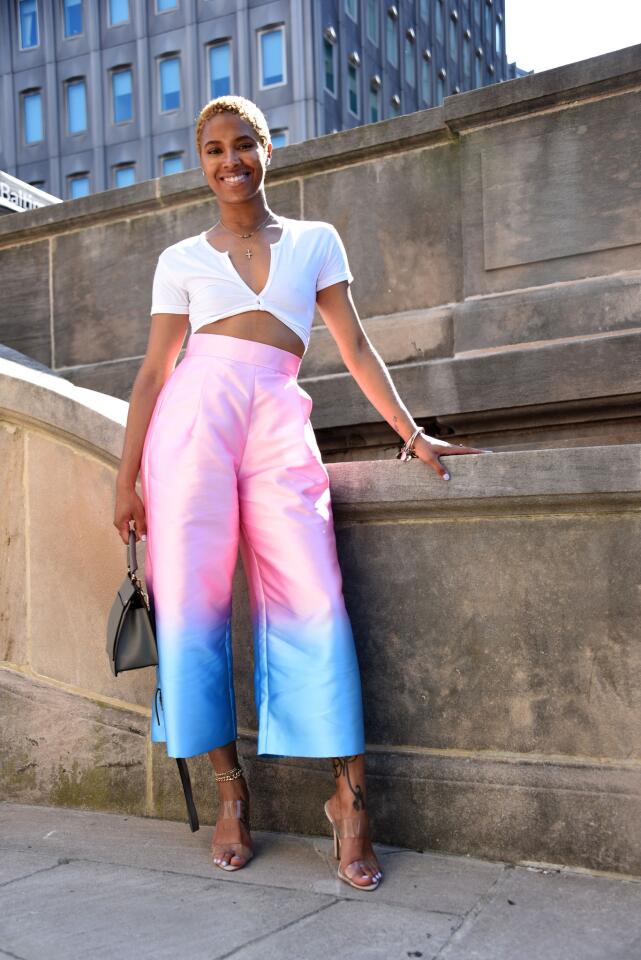 Who: Morgan Baker, 31, Park Heights resident, Maryland Stadium Authority senior project coordinator Spotted at: “Rosé in the Garden,” a summer soirée presented by Downtown Partnership of Baltimore at Preston Gardens, downtown Baltimore What she wore: White cotton cropped top and clear vinyl stiletto heels from asos.com; pink-to-aqua ombre taffeta culottes from thebrand-label.com; cross necklace that was a gift; chakra necklace from etsy.com; Furla gray bag she bought in Paris, France; and Alex and Ani bangles from her mother. Her self-described style: “Fun. Bright colors; things that are an extension of myself.”