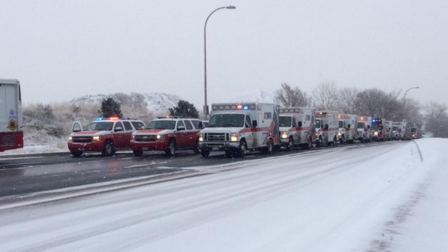 More than a dozen ambulances sit ready to respond about 2 miles from a Planned Parenthood clinic that was the scene of a shooting in Colorado Springs, Colo., on Nov. 27, 2015.