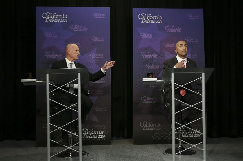 Gov. Jerry Brown, left, gestures as Republican challenger Neel Kashkari speaks during a gubernatorial debate in Sacramento on Thursday. Brown said he will sign a bill that would ban single-use, plastic grocery bags statewide. Kashkari criticized the ban.