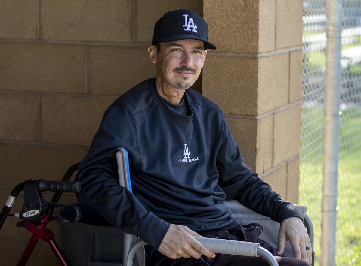 Los Amigos baseball coach Aaron Pines sits in the dugout following a game against Santiago on April 5.