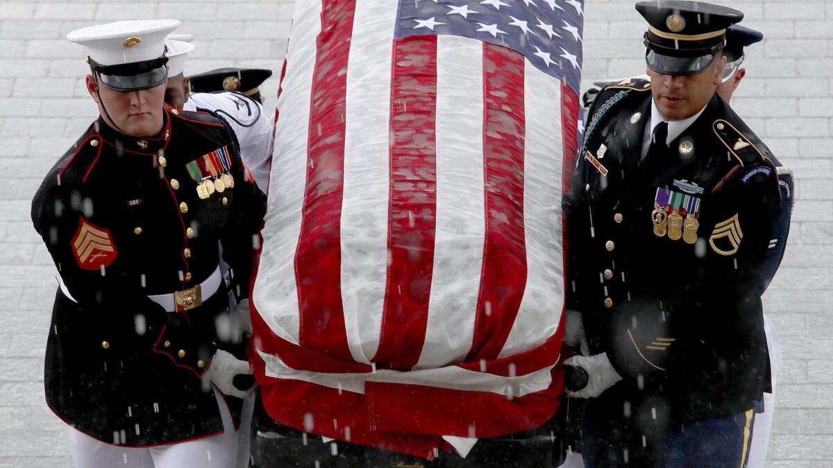 A military honor guard team carries the casket of Sen. John McCain into the U.S. Capitol on Friday.