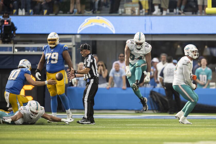Miami Dolphins defensive tackle Christian Wilkins (94) and linebacker Jaelan Phillips (15) react after Los Angeles Chargers quarterback Justin Herbert (10) gets sacked during an NFL football game, Sunday, Sept. 10, 2023, in Inglewood, Calif. (AP Photo/Kyusung Gong)