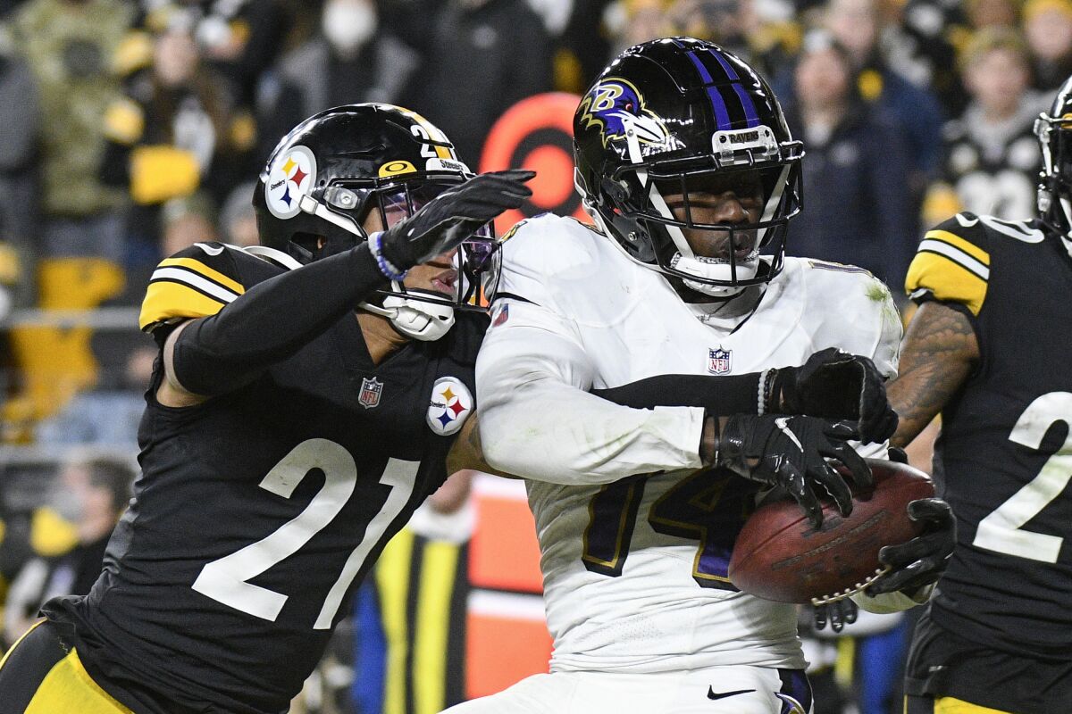 FILE - Baltimore Ravens wide receiver Sammy Watkins (14) makes a touchdown catch as Pittsburgh Steelers cornerback Tre Norwood (21) defends during the second half of an NFL football game Dec. 5, 2021, in Pittsburgh. Watkins is heading to Green Bay as the Packers attempt to rebuild their receiving corps after losing All-Pro Davante Adams. Packers general manager Brian Gutekunst announced the addition of Watkins on Thursday, April 14, 2022. (AP Photo/Don Wright, File)