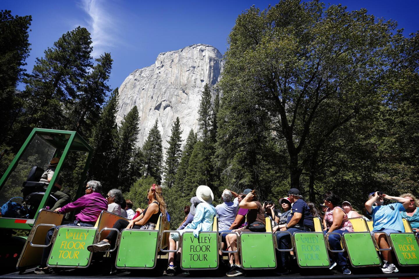 Visitors pass the El Capitan rock formation at Yosemite National Park. Two young campers died Aug. 14 when a tree limb fell on their tent as they slept.