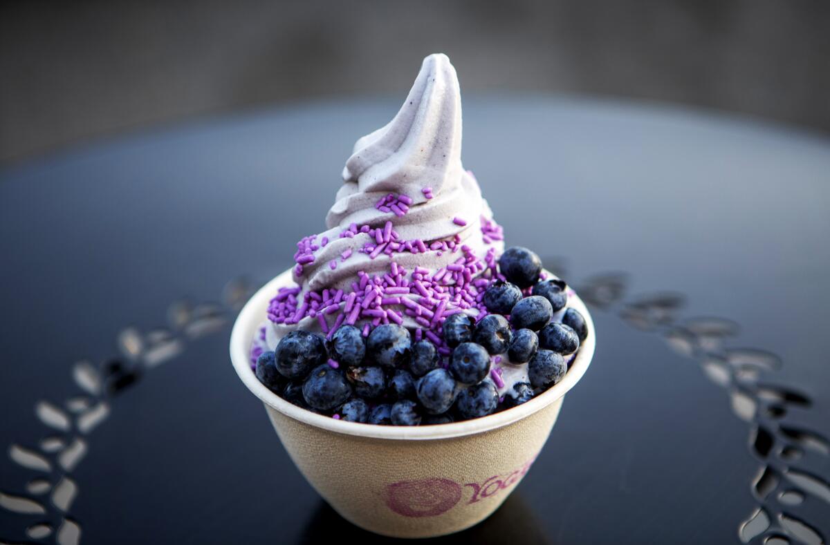 A swirl of lavender blossom soft serve at Yoga-urt, with blueberries and lavender sprinkles.