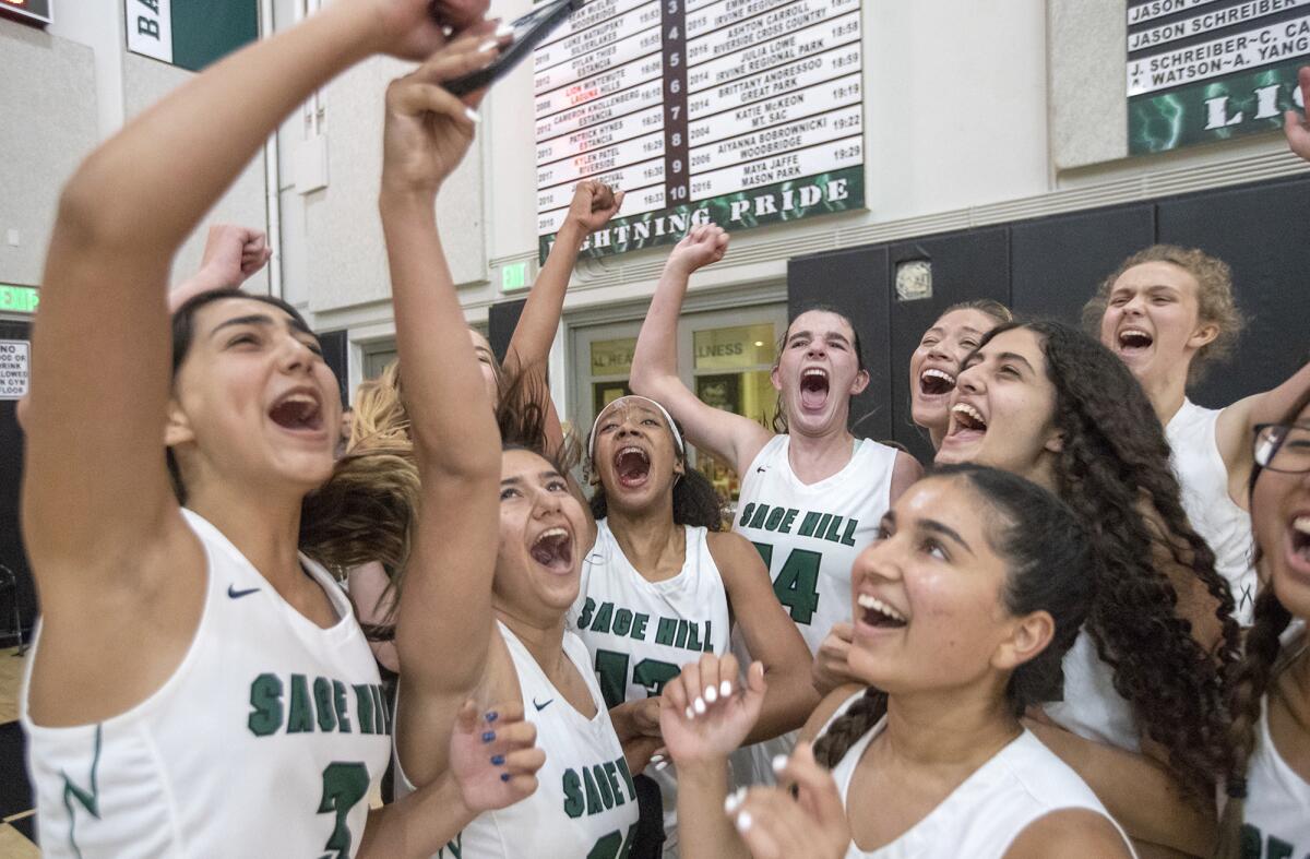 Sage Hill celebrates a 62-55 win over Ontario Christian in the CIF Southern Section Division 3AA girls' basketball final.