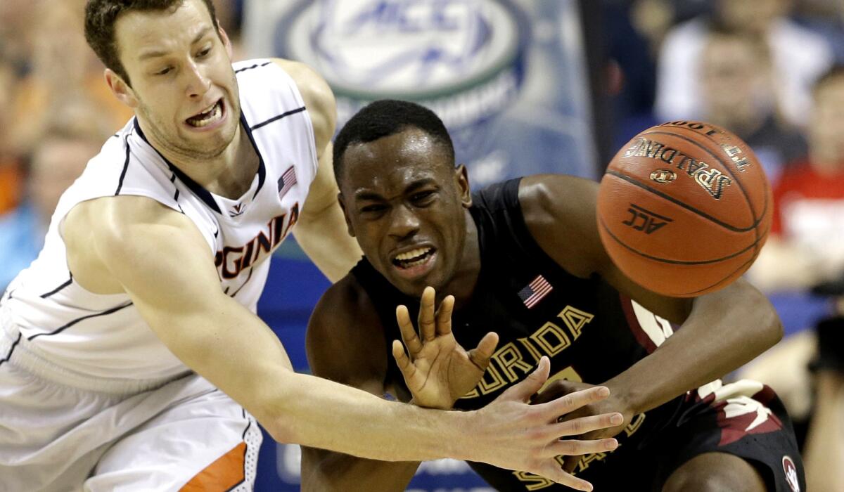 Virginia forward Evan Nolte, left, knocks the ball from Florida State guard Montay Brandon during the second half of an Atlantic Coast Conference tournament quarterfinal in Greensboro, N.C., on Thursday.