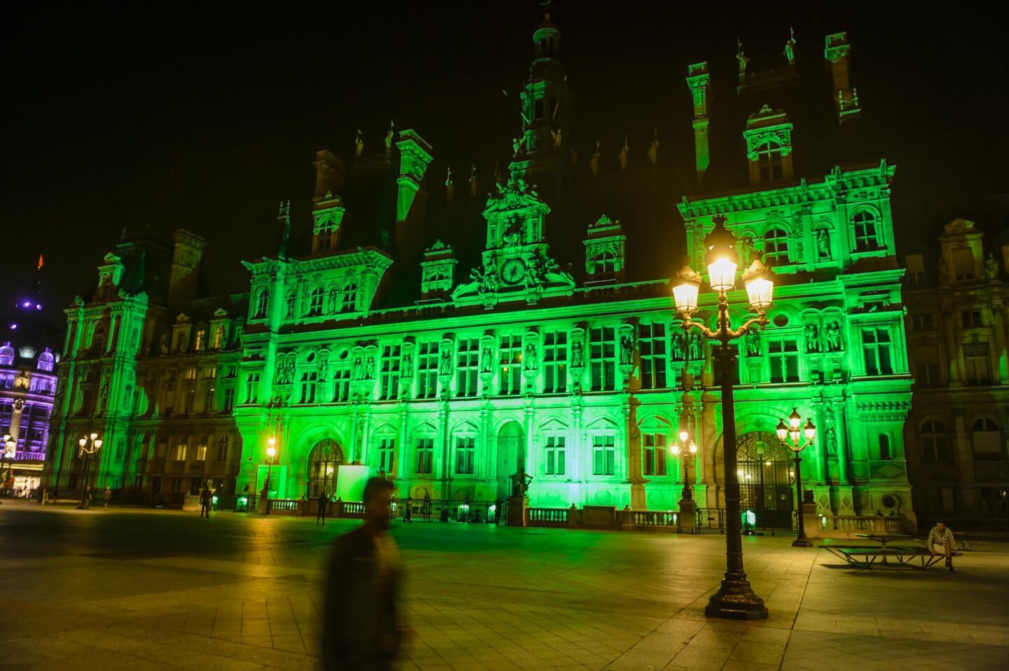 Paris' City Hall is illuminated in green to mark the disapproval of the French capital and its mayor, Anne Hidalgo, after the decision by U.S. President Trump to withdraw from the Paris climate agreement.