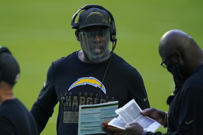 Los Angeles Chargers head coach Anthony Lynn, center, talks to his staff on the sidelines.