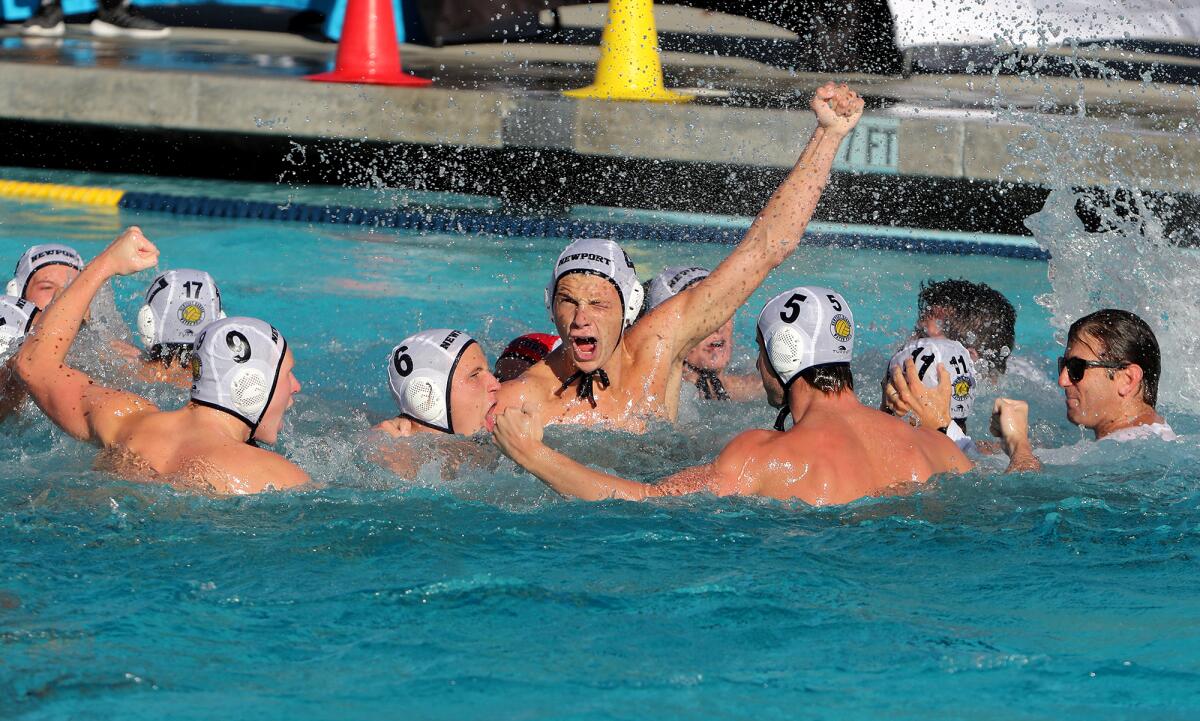 Newport Harbor sophomore Peter Castillo, center, cheers with teammates after the Sailors defeated Huntington Beach.