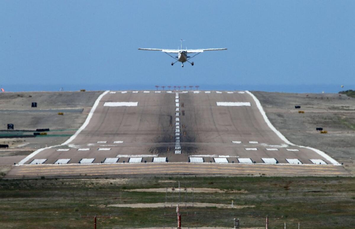A plane lands at McClellan-Palomar Airport in Carlsbad.
