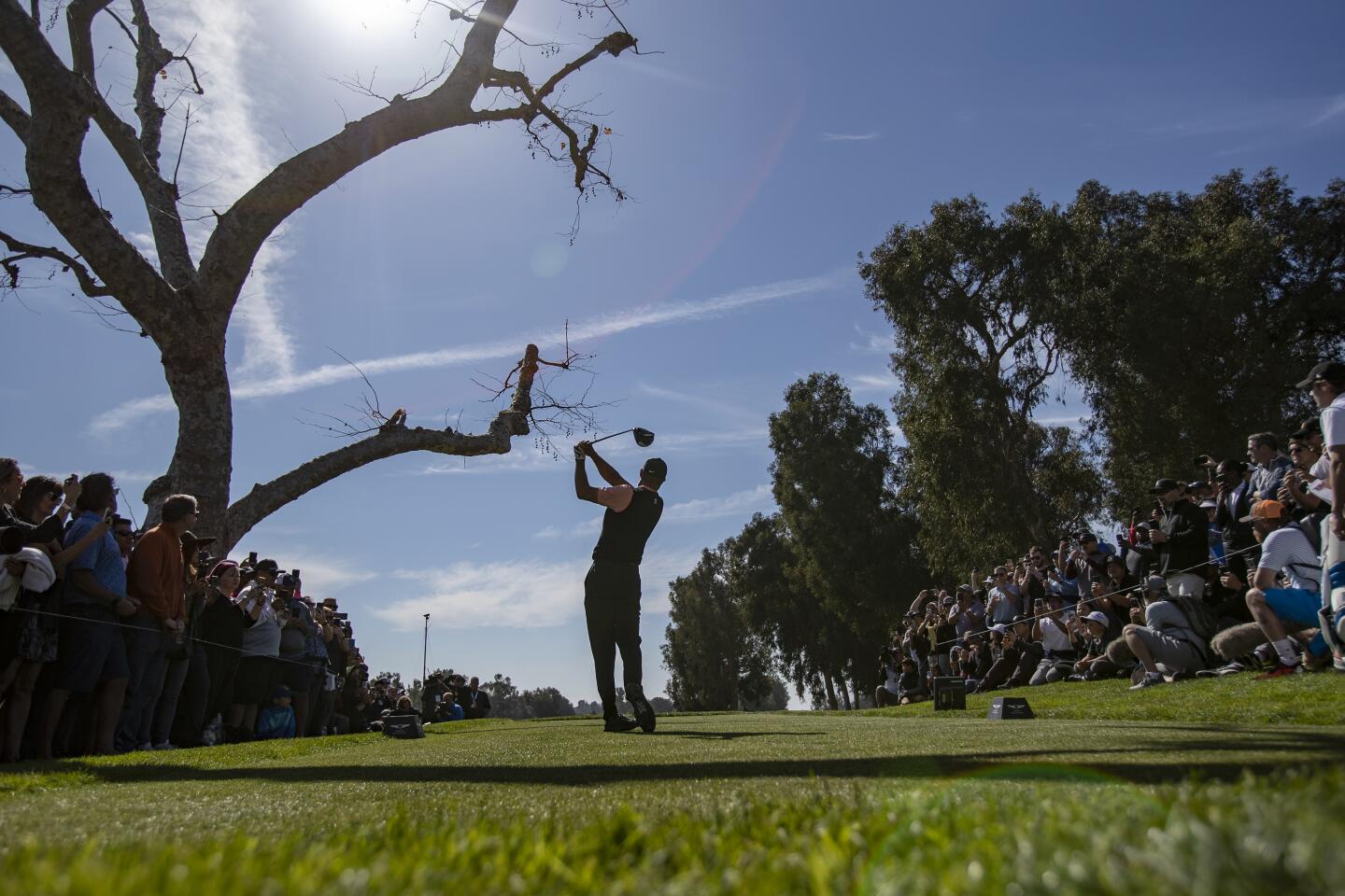 Tiger Woods hits off the third tee during the first round of the Genesis Invitational at Riviera Country Club on Feb. 13, 2020.