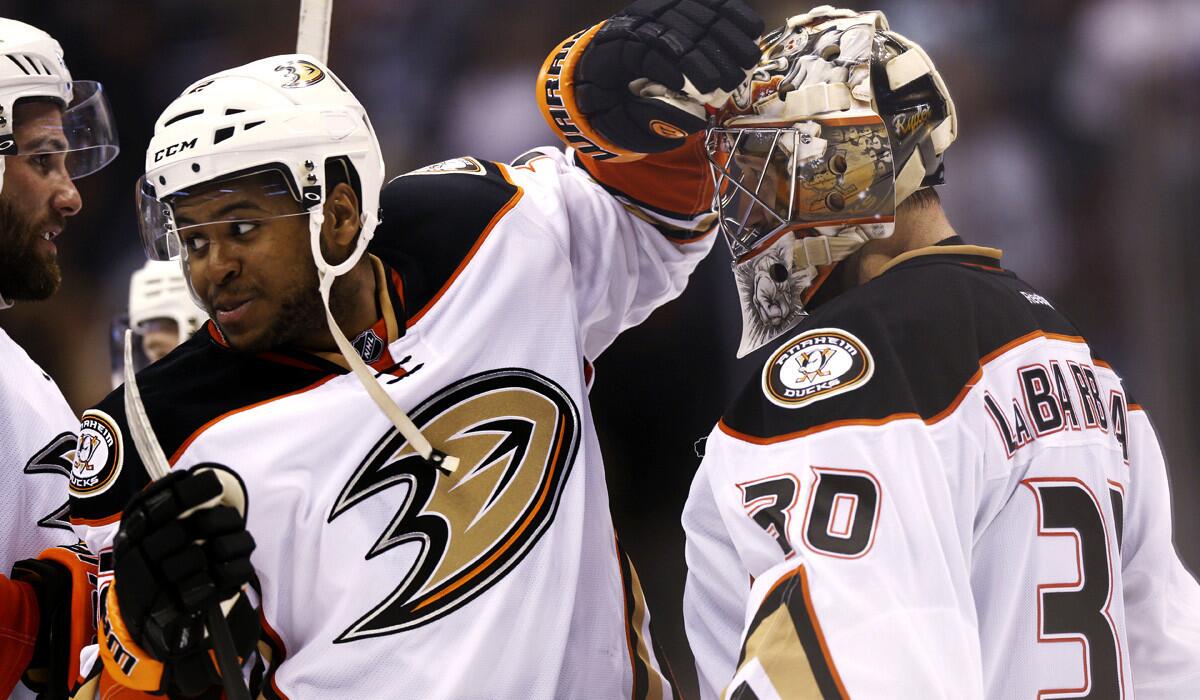 Ducks right wing Devante Smith-Pelly congratulates goalie Jason LaBarbera after the Ducks' 3-2 victory over the Colorado Avalanche on Sunday in Denver.