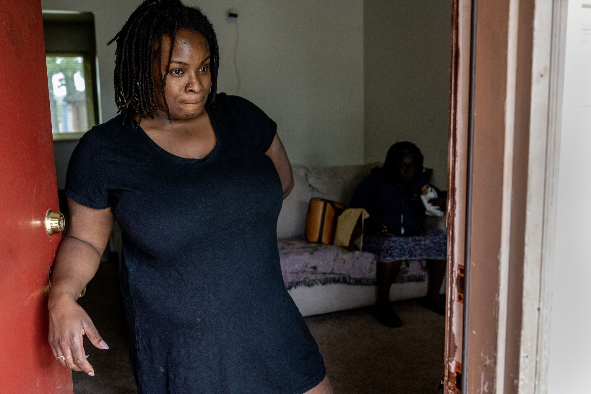 Tyeshia Smith, 31, stands in a doorway.