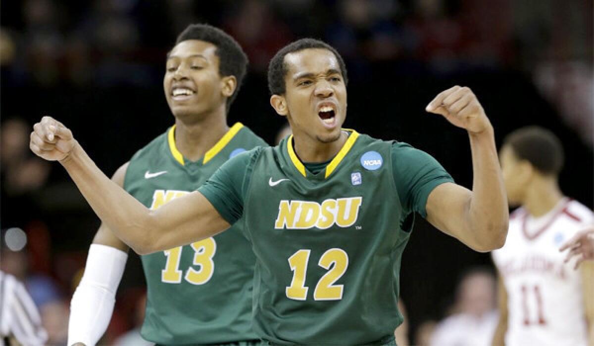 Lawrence Alexander of 12th-seeded North Dakota State celebrates during the Bison's upset of fifth-seeded Oklahoma, 80-75, in overtime of the second round of the NCAA tournament.