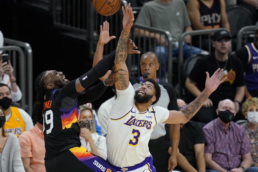 Los Angeles Lakers forward Anthony Davis (3) blocks the shot of Phoenix Suns forward Jae Crowder.