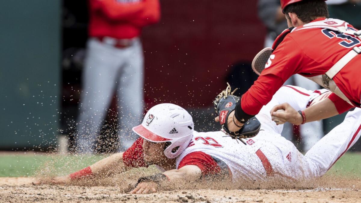 North Carolina State's Will Wilson slides into home under the tag of Radford's Will Harless on May 5.
