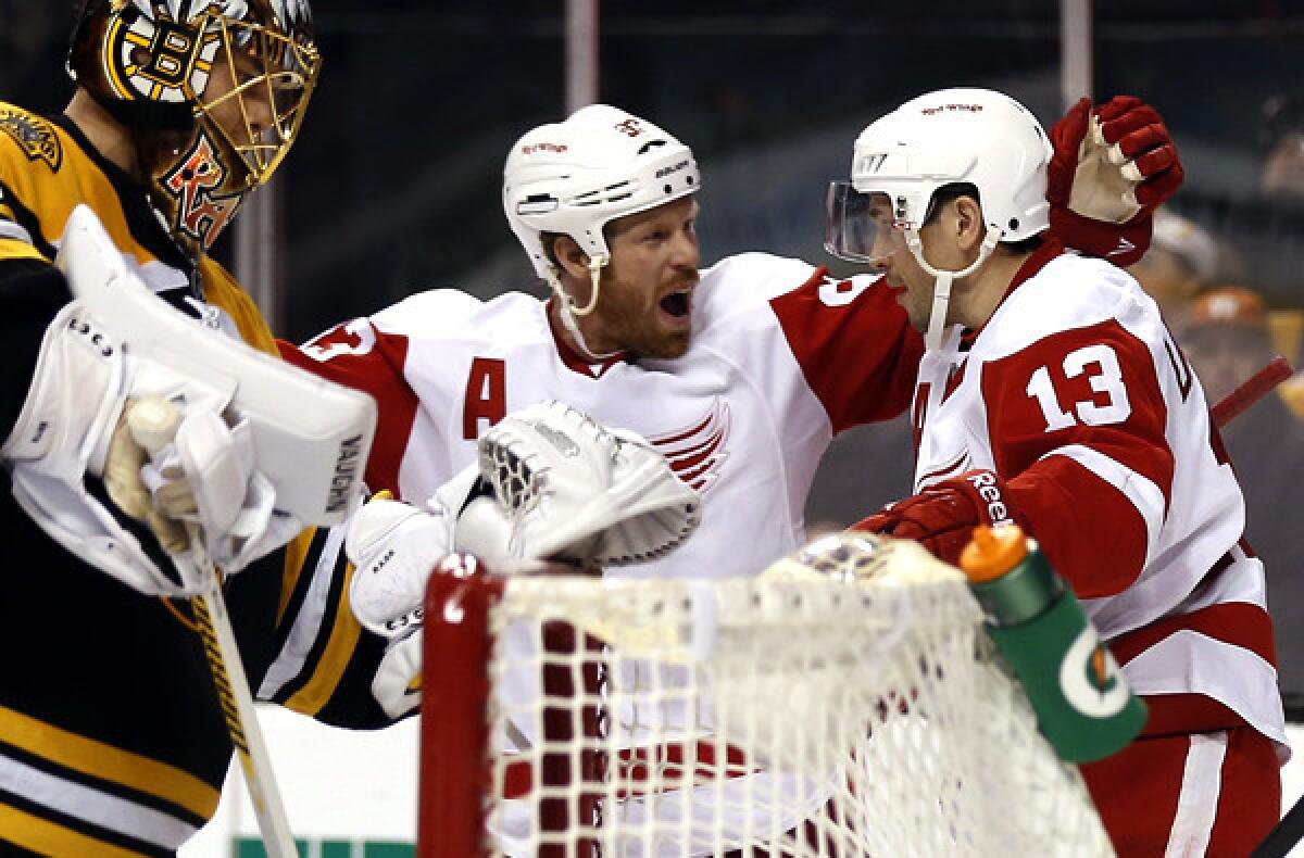 Red Wings center Pavel Datsyuk (13) is congratulated by teammate Johan Franzen after scoring against Bruins goalie Tuukka Rask, left, in the third period Friday night in Boston.