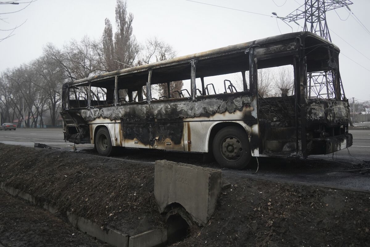 A bus, which was burned during clashes, is seen on a street in Almaty, Kazakhstan, Sunday, Jan. 9, 2022. Kazakhstan's health ministry says 164 people have been killed in protests that have rocked the country over the past week. President Kassym-Jomart Tokayev's office said Sunday that order has stabilized in the country and that authorities have regained control of administrative buildings that were occupied by protesters, some of which were set on fire. (Vladimir Tretyakov/NUR.KZ via AP)