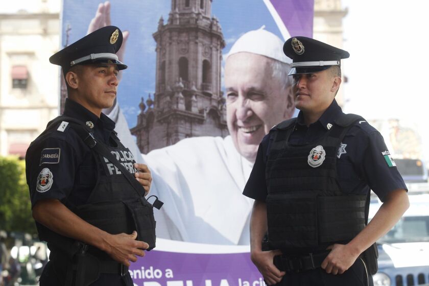 Federal police agents stand guard in Morelia, the capital of the Mexican state of Michoacan. Security will be tight when Pope Francis visits Morelia on Feb. 16.