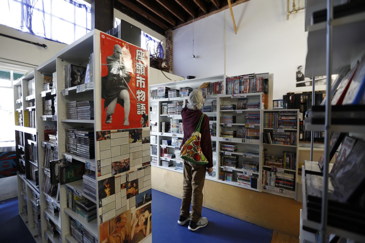 A customer browses the DVD collection at Videotheque in South Pasadena on April 11.