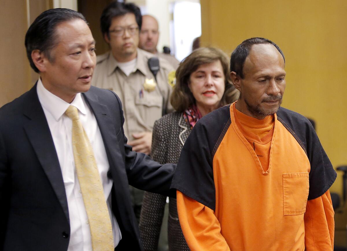 Juan Francisco Lopez-Sanchez, right, is led into a courtroom by San Francisco Public Defender Jeff Adachi on July 7. A judge on Friday ruled that Lopez-Sanchez will stand trial in the death of San Francisco resident Kathryn Steinle.