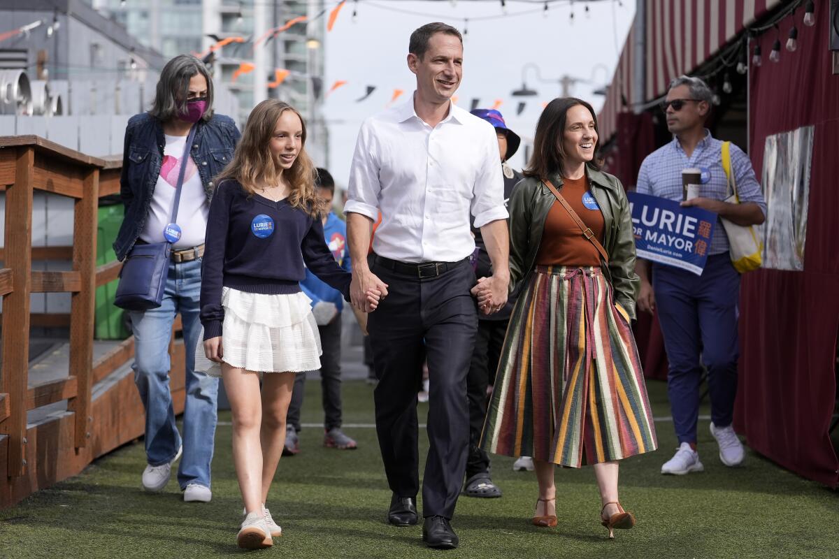 San Francisco Mayor Daniel Lurie walks with his daughter, Taya, and wife, Becca Prowda.