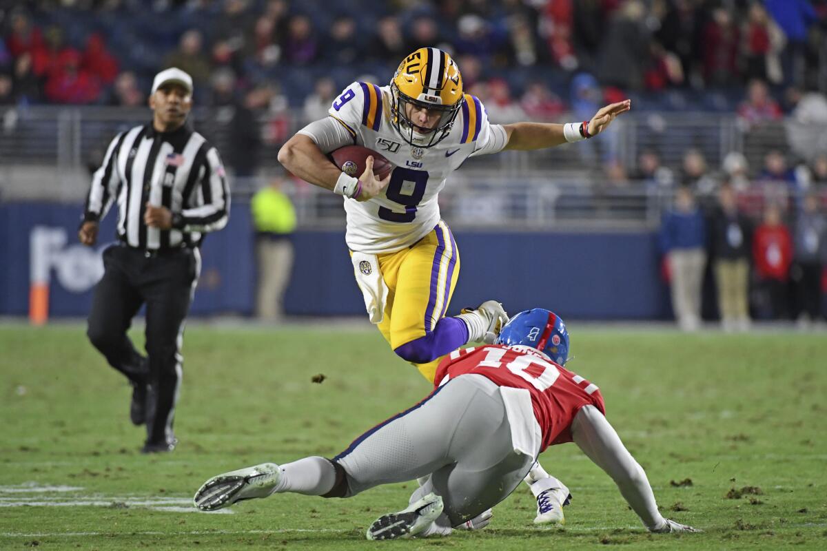 Louisiana State quarterback Joe Burrow avoids a University of Mississippi linebacker at a Nov. 16 game in Oxford, Miss. 