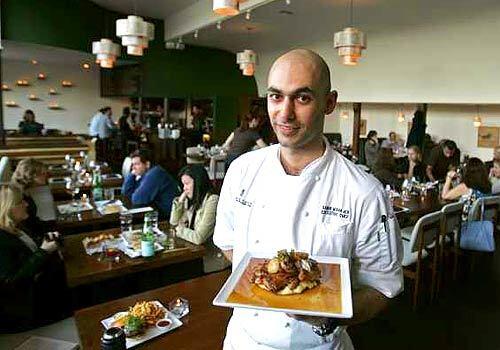 Chef Samir Mohajer shows off pan-roasted half chicken with caramelized pearl onions thats generous enough to share.