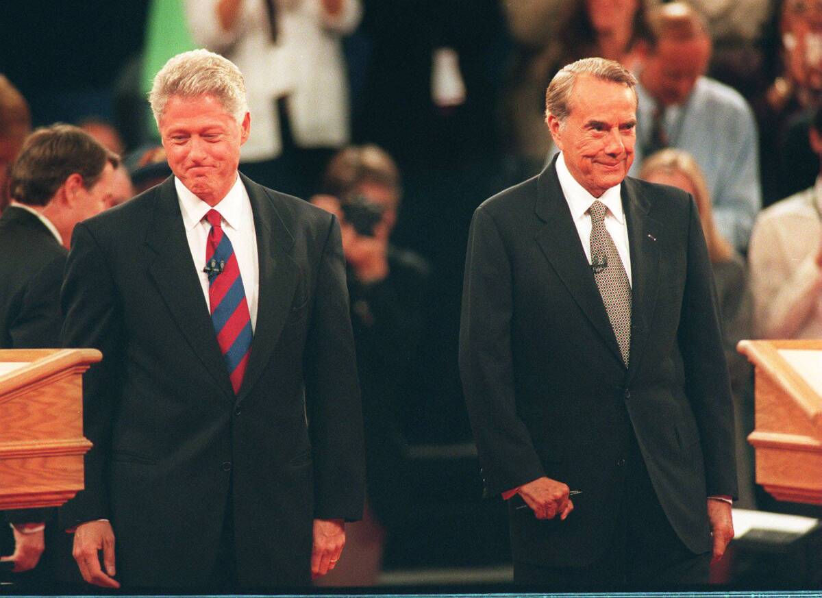 President Bill Clinton and presidential candidate Bob Dole grin and grimace at USD in October 1996.