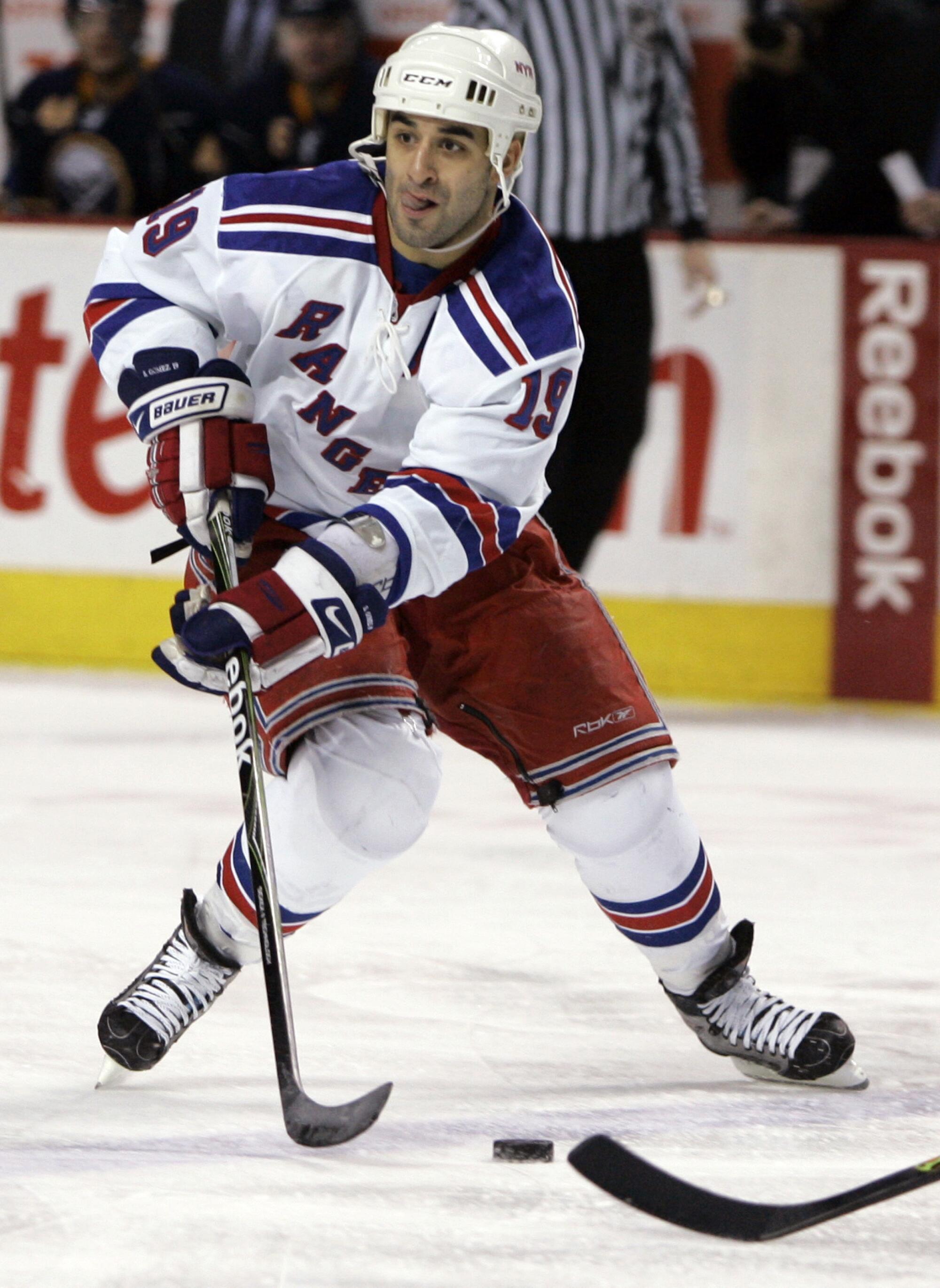 The Rangers' Scott Gomez looks to pass during the second period of a 2009 NHL game against the Sabres 