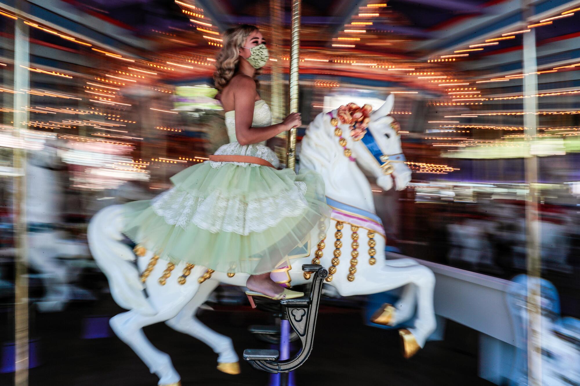 A woman riding a carousel at Disneyland.