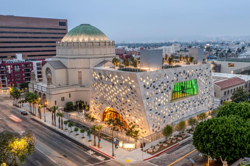 The Audrey Irmas pavilion is seen from overhead at dusk, with its angled windows illuminated from within