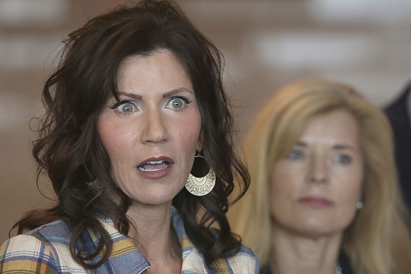 FILE - In this Wednesday, March 18, 2020 file photo, South Dakota Gov. Kristi Noem, left, updates media on the COVID-19 pandemic during a press conference at Monument Health in Rapid City, S.D. Noem says she is activating the National Guard to set up temporary hospitals in Sioux Falls and Rapid City. (Jeff Easton/Rapid City Journal via AP, File)