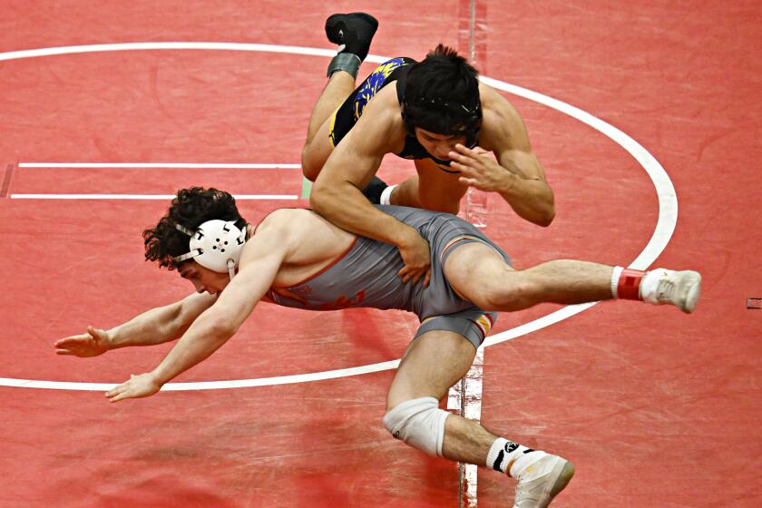 La Costa Canyon's Tanner Smith, left, wrestles Brawley High School's Caleb Ramirez during the Division 3 boys wrestling finals at Montgomery High School February, 10, 2024 in San Diego, Calif. (Photo by Denis Poroy)