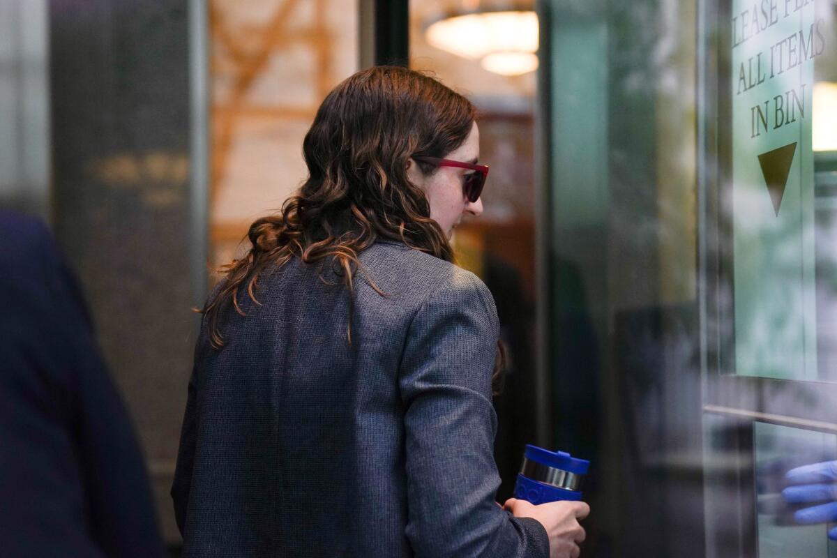 Sam Bankman-Fried's former girlfriend, Caroline Ellison, walks through security at Manhattan Federal Court in New York.