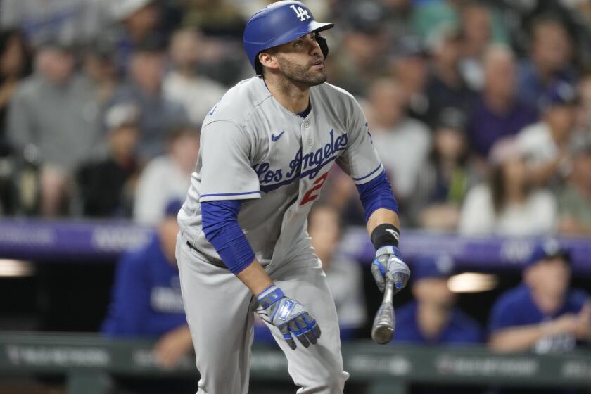 Los Angeles Dodgers' J.D. Martinez watches his two-run home run against the Colorado Rockies during the fourth inning of a baseball game Thursday, June 29, 2023, in Denver. (AP Photo/David Zalubowski)
