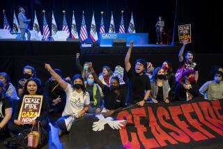 Pro-Palestinian demonstrators sit in front of the stage, disrupting the afternoon session of the 2023 California Democratic Party November State Endorsing Convention, Saturday, Nov. 18, 2023, at SAFE Credit Union Convention Center in Sacramento, Calif. (Lezlie Sterling/The Sacramento Bee via AP)