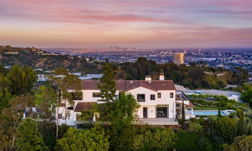 Built in 2001, the hilltop home expands to a scenic backyard with a lawn, swimming pool and sweeping city views.
