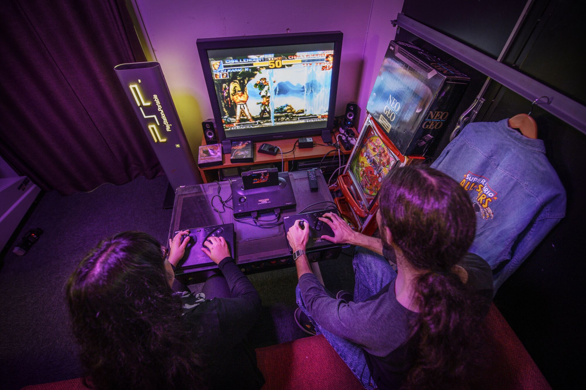 A view from above of two people playing a video game in a room