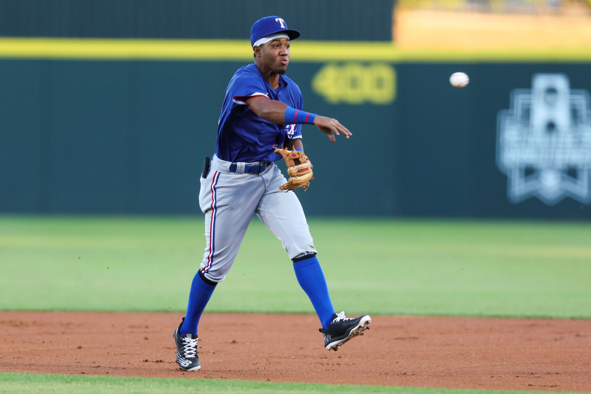 Second baseman Echedry Vargas, a Rangers prospect, throws a ball to first 